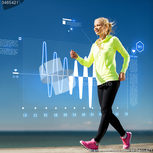 Image of smiling woman doing sports outdoors with earphones