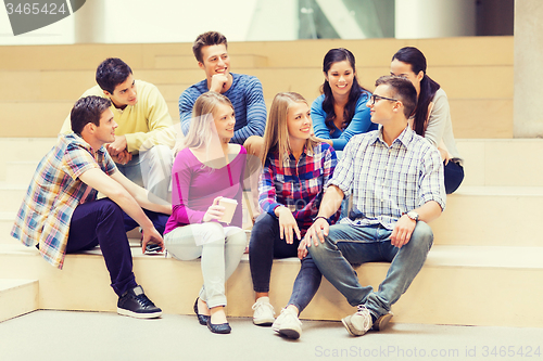 Image of group of smiling students with paper coffee cups