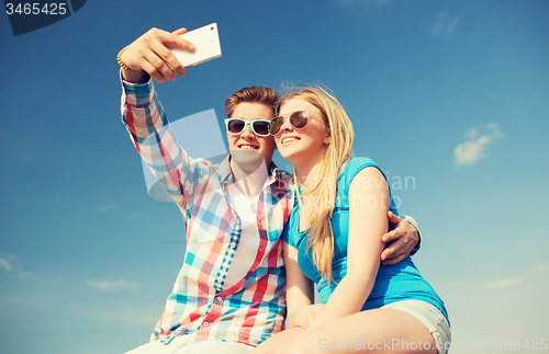 Image of smiling couple having fun outdoors