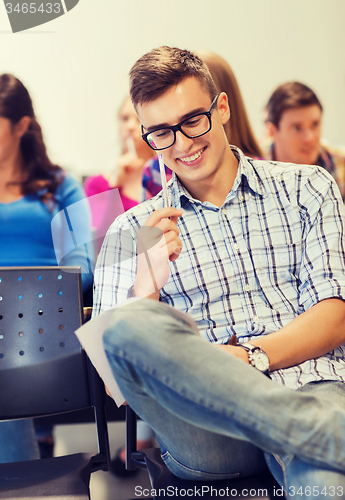 Image of group of smiling students with notebook