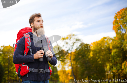 Image of man with backpack and binocular outdoors