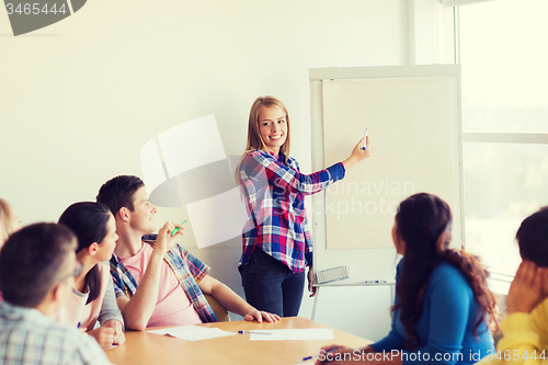 Image of group of smiling students with white board