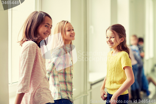 Image of group of smiling school kids in corridor