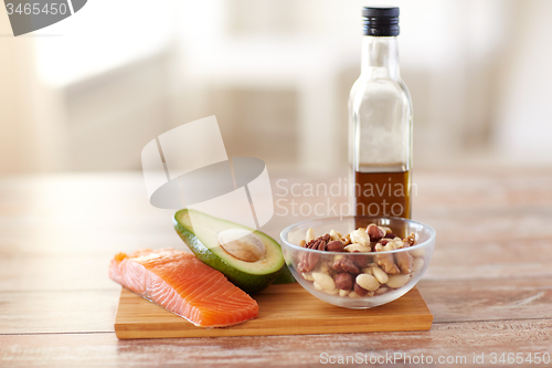 Image of close up of food and olive oil bottle on table