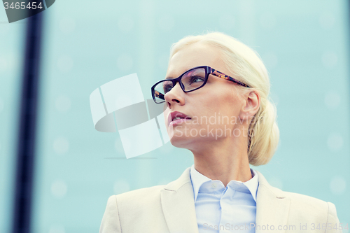 Image of young businesswoman over office building