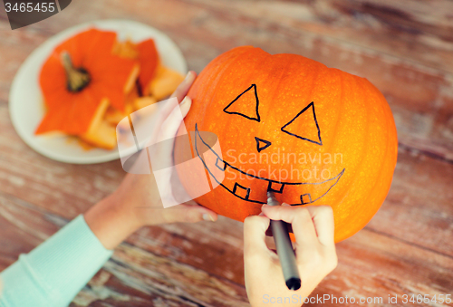 Image of close up of woman with pumpkins at home