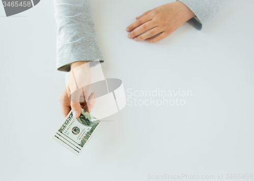Image of close up of woman hands holding us dollar money