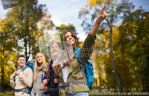 Image of group of smiling friends with backpacks hiking