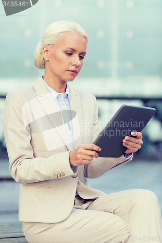 Image of businesswoman working with tablet pc outdoors