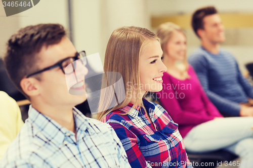 Image of group of smiling students in lecture hall