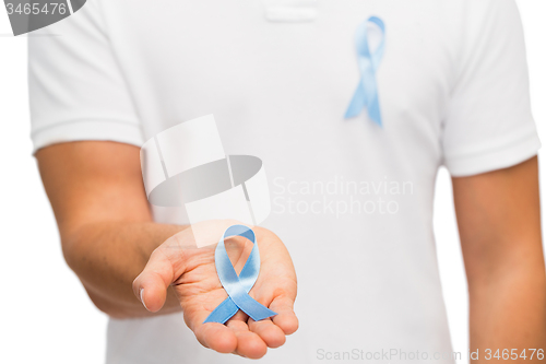 Image of hand with blue prostate cancer awareness ribbon