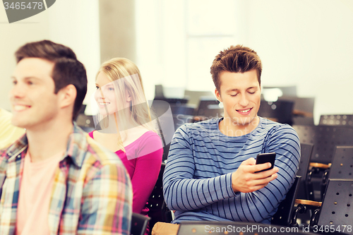 Image of group of smiling students in lecture hall