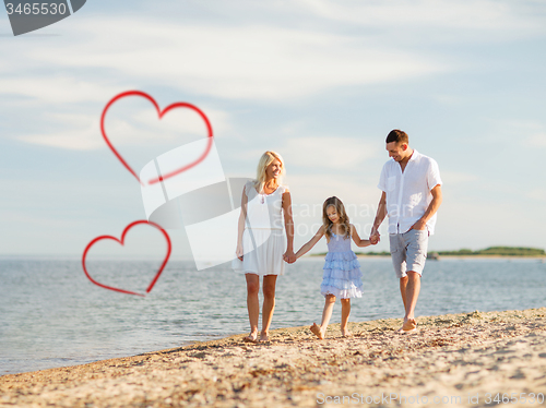 Image of happy family walking at the seaside