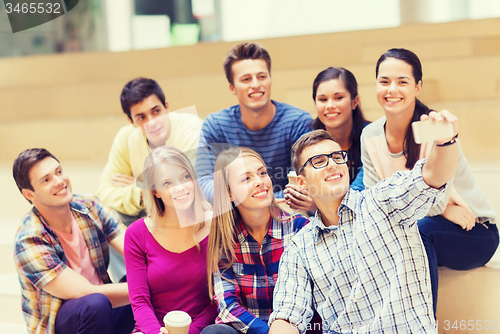 Image of group of students with smartphone and coffee cup