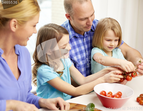 Image of happy family with two kids cooking at home