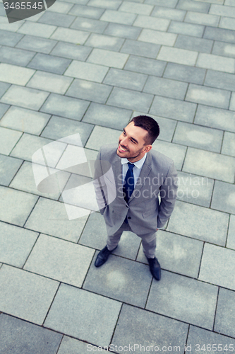Image of young smiling businessman outdoors from top