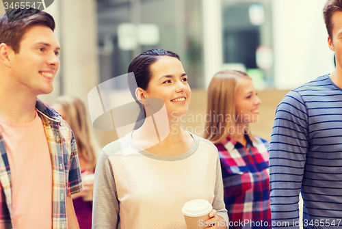 Image of group of smiling students with paper coffee cups