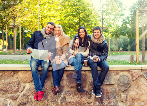 Image of group of friends with map outdoors