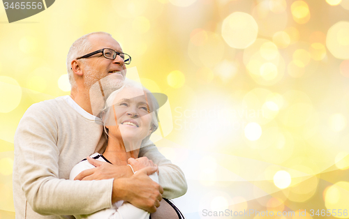 Image of happy senior couple over holiday lights background