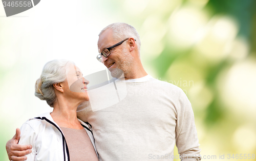 Image of happy senior couple over green natural background