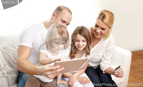 Image of happy family with tablet pc and credit card