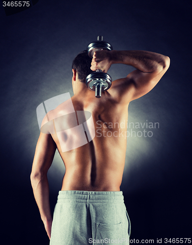 Image of young man with dumbbell