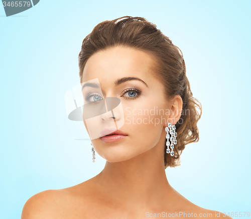 Image of woman wearing shiny diamond earrings