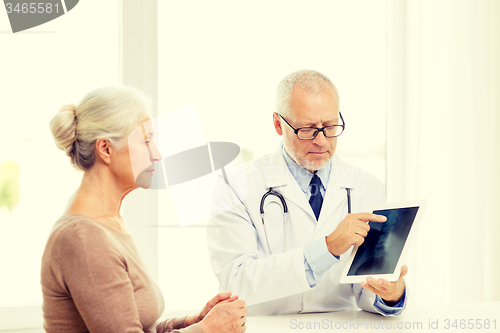 Image of senior woman and doctor with tablet pc