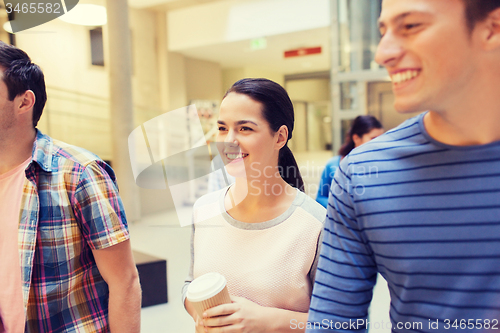 Image of group of smiling students with paper coffee cups