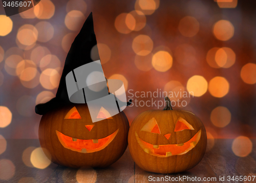 Image of close up of pumpkins over holiday lights background