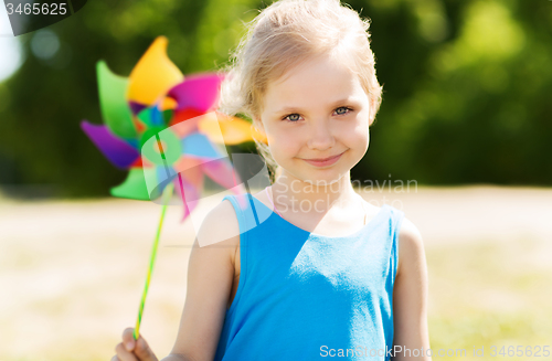 Image of happy little girl with colorful pinwheel at summer