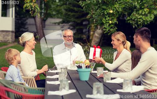 Image of happy family having holiday dinner outdoors