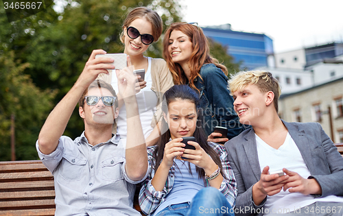 Image of students or teenagers with smartphones at campus