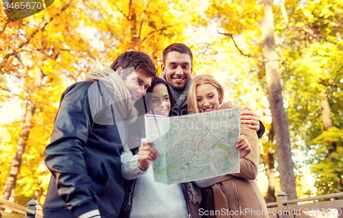 Image of group of friends with map outdoors
