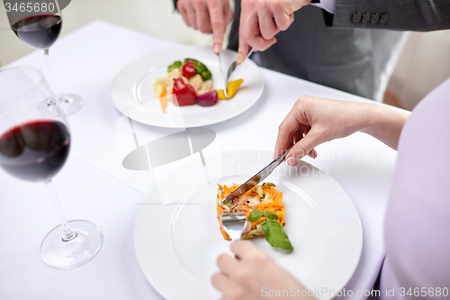 Image of close up of couple eating appetizers at restaurant