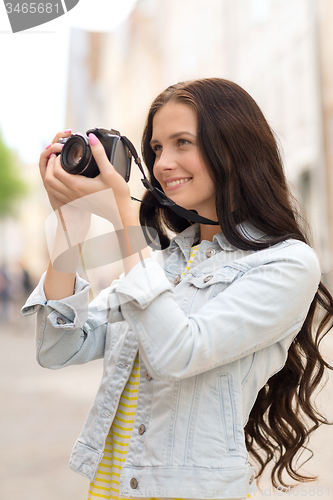 Image of smiling teenage girl with camera