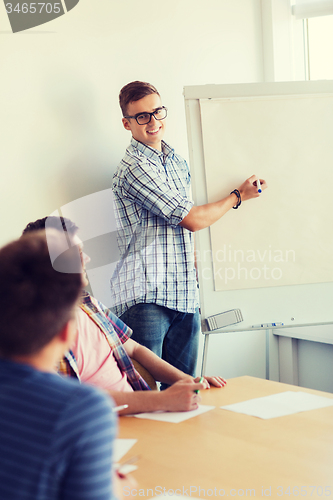 Image of group of smiling students with white board