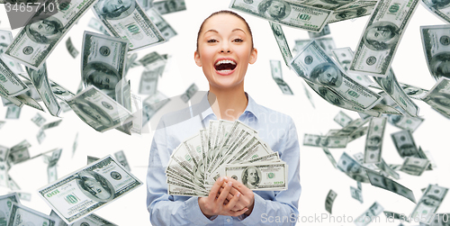 Image of smiling businesswoman with dollar cash money