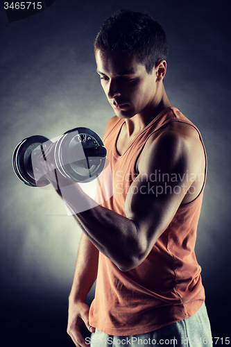 Image of young man with dumbbell