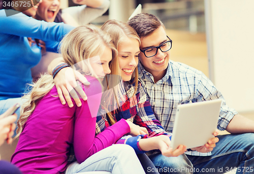 Image of group of smiling students with tablet pc