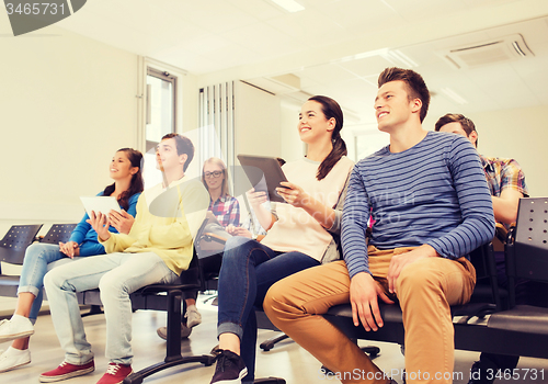 Image of group of smiling students with tablet pc