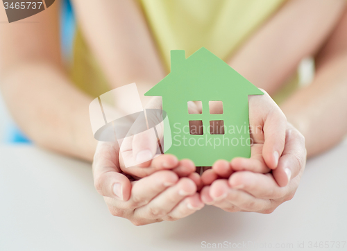 Image of close up of woman and girl hands with paper house