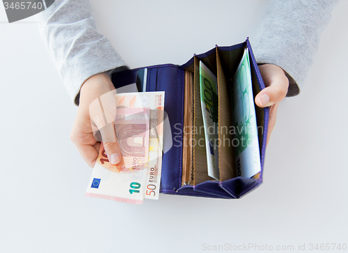 Image of close up of woman hands with wallet and euro money