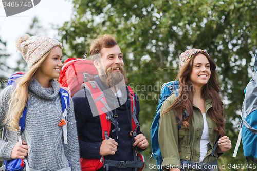 Image of group of smiling friends with backpacks hiking