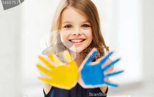 Image of girl showing painted hands