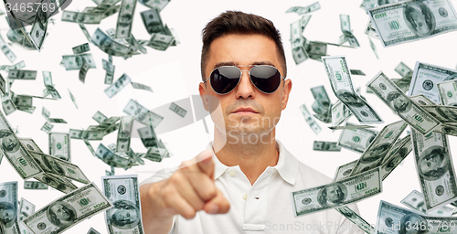 Image of man pointing on you with falling dollar money