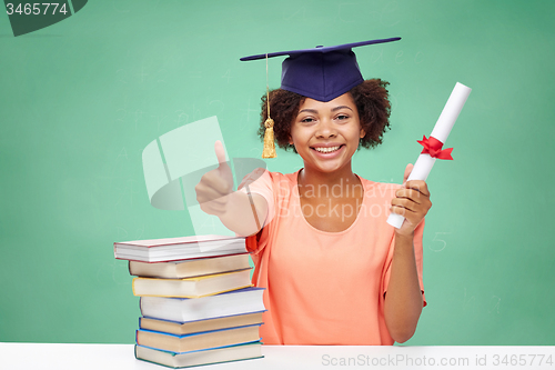 Image of happy african bachelor girl with books and diploma