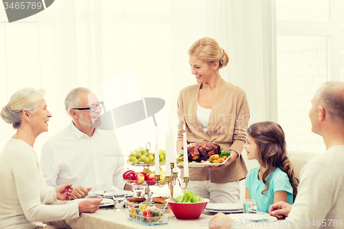 Image of smiling family having holiday dinner at home