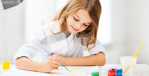 Image of little girl painting at school