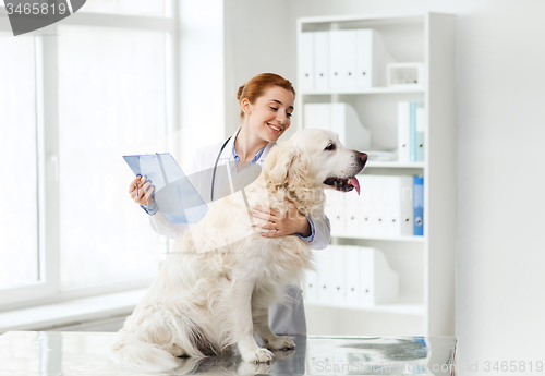 Image of happy doctor with retriever dog at vet clinic